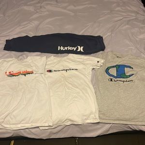 Three Champion shirts and one pair of Hurley sweat pants selling as a bundle